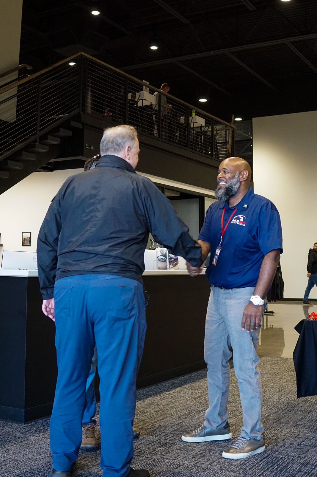 A MABA Board member shaking hands with an arriving guest